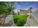 Wide backyard showcasing desert landscaping, artificial turf, and a covered patio, great for relaxing outdoors at 2850 N 152Nd Ln, Goodyear, AZ 85395