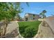 Expansive backyard featuring lush artificial turf, desert landscaping, and a cozy patio area perfect for entertaining at 2850 N 152Nd Ln, Goodyear, AZ 85395