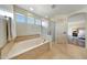 Bathroom features a soaking tub with tile surround and a separate glass shower at 2850 N 152Nd Ln, Goodyear, AZ 85395