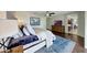 Spacious main bedroom with a ceiling fan, wood floors, and a blue rug at 2850 N 152Nd Ln, Goodyear, AZ 85395