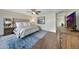 Spacious main bedroom with a ceiling fan, wood floors, and a blue rug at 2850 N 152Nd Ln, Goodyear, AZ 85395