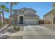 Charming two-story home with a desert landscape and a spacious driveway at 2850 N 152Nd Ln, Goodyear, AZ 85395