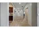 Hallway featuring tile flooring, views of the front door, and connections to various rooms at 2850 N 152Nd Ln, Goodyear, AZ 85395
