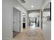 Inviting hallway with tile flooring, arched doorways, and views into multiple living spaces at 2850 N 152Nd Ln, Goodyear, AZ 85395