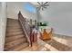 Bright living room with hardwood floors, a vaulted ceiling, and stairway with wood banister at 2850 N 152Nd Ln, Goodyear, AZ 85395