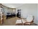 A serene office area with a large desk, comfortable seating, and shelves for storage and decor at 2850 N 152Nd Ln, Goodyear, AZ 85395