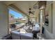 Comfortable covered patio with seating area, grill, and view of the pool and landscaped backyard at 2850 N 152Nd Ln, Goodyear, AZ 85395