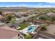 Aerial view of home showcasing the pool and lush green artificial turf creating a tranquil outdoor retreat at 31106 N 130Th Ln, Peoria, AZ 85383