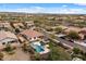 Wide aerial view of a home and neighborhood showcasing the beautiful desert landscape and the community at 31106 N 130Th Ln, Peoria, AZ 85383