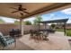 Inviting covered patio with dining and lounge seating, perfect for outdoor entertainment at 31106 N 130Th Ln, Peoria, AZ 85383