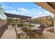 Beautiful backyard with pergola, dining set, lounge seating, grass, and swimming pool at 31106 N 130Th Ln, Peoria, AZ 85383