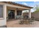 Covered patio with ceiling fan, dining set and lounge seating for relaxing outdoor living at 31106 N 130Th Ln, Peoria, AZ 85383