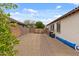 Spacious backyard featuring a mix of gravel and brick accents with a gate for added privacy and security at 31106 N 130Th Ln, Peoria, AZ 85383