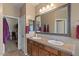 Bathroom with double sinks, framed mirror and vanity with tile countertop at 31106 N 130Th Ln, Peoria, AZ 85383