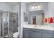 Modern bathroom with gray vanity, walk-in shower, and large mirror at 31106 N 130Th Ln, Peoria, AZ 85383