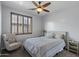 Bright bedroom featuring wood shutters, ceiling fan, and a comfortable queen bed at 31106 N 130Th Ln, Peoria, AZ 85383