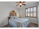 Bedroom with wood shutters and a ceiling fan for a tranquil retreat at 31106 N 130Th Ln, Peoria, AZ 85383