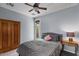 Cozy bedroom featuring neutral walls, ceiling fan, and wood wardrobe for ample storage space at 31106 N 130Th Ln, Peoria, AZ 85383