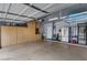 Spacious garage with ample cabinet space, refrigerator, and utility sink at 31106 N 130Th Ln, Peoria, AZ 85383