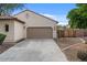 Home exterior features a spacious driveway, two-car garage, and a gated side yard for added convenience at 31106 N 130Th Ln, Peoria, AZ 85383