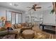 Relaxing living room features hardwood floors, plantation shutters, and a billiard table at 31106 N 130Th Ln, Peoria, AZ 85383