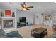 Bright living room with a fireplace and views to the kitchen at 31106 N 130Th Ln, Peoria, AZ 85383