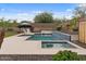 Sparkling pool with baja step, hot tub, lush landscaping, and lounge chairs for relaxation at 31106 N 130Th Ln, Peoria, AZ 85383