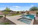 Inviting backyard with a refreshing pool, spa, patio area and lush landscaping, perfect for relaxing and entertaining at 31106 N 130Th Ln, Peoria, AZ 85383