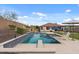 Resort-style pool and spa with diving board, surrounded by a spacious patio and lush landscaping offering ultimate relaxation at 31106 N 130Th Ln, Peoria, AZ 85383