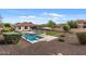 Gorgeous private backyard with pool, diving board, lush landscaping, and patio perfect for outdoor entertaining at 31106 N 130Th Ln, Peoria, AZ 85383