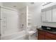 Well-lit bathroom with a shower-tub combo, granite vanity, a modern toilet and tiled flooring at 3302 N 7Th St # 211, Phoenix, AZ 85014