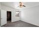 Bright bedroom featuring a ceiling fan, walk-in closet, plush carpet, and a window with neighborhood views at 3302 N 7Th St # 211, Phoenix, AZ 85014