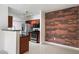Open kitchen featuring stainless steel appliances and contrasting brick accent wall, with updated countertops at 3302 N 7Th St # 211, Phoenix, AZ 85014