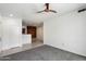 Bright living room showcasing a modern ceiling fan and an inviting view into the stylish kitchen at 3302 N 7Th St # 211, Phoenix, AZ 85014