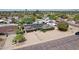 An aerial view captures the home's solar panels, pool, and landscaped surroundings at 3830 E Desert Cove Ave, Phoenix, AZ 85028