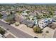 Expansive aerial view of a suburban neighborhood showcasing backyard pools and solar panels at 3830 E Desert Cove Ave, Phoenix, AZ 85028