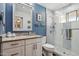 Stylish bathroom with blue walls, decorative tile accents, and glass shower enclosure at 3830 E Desert Cove Ave, Phoenix, AZ 85028