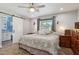 Charming bedroom features a sliding barn door to bathroom and natural light at 3830 E Desert Cove Ave, Phoenix, AZ 85028