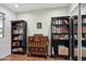 Bedroom with a window showing greenery, bookshelves, and hardwood floors at 3830 E Desert Cove Ave, Phoenix, AZ 85028