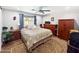 Comfortable bedroom with a ceiling fan, multiple dressers, and a patterned rug for a warm and inviting space at 3830 E Desert Cove Ave, Phoenix, AZ 85028