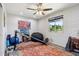Bedroom features large window with natural light, ceiling fan, and exercise equipment at 3830 E Desert Cove Ave, Phoenix, AZ 85028