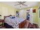 Bedroom with ceiling fan, wood floors, and view of the attached bathroom at 3830 E Desert Cove Ave, Phoenix, AZ 85028