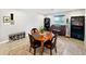This dining area has a round table, bookshelf, piano, bench and light-colored floor tiles with a decorative rug at 3830 E Desert Cove Ave, Phoenix, AZ 85028