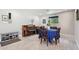 A cozy dining room and piano room is lit by a window showing greenery at 3830 E Desert Cove Ave, Phoenix, AZ 85028