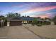Charming single-story home with solar panels, desert landscaping, and a two-car garage at 3830 E Desert Cove Ave, Phoenix, AZ 85028