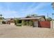 Charming home with solar panels, showcasing sustainability and a well-maintained front yard at 3830 E Desert Cove Ave, Phoenix, AZ 85028