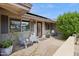 Inviting front porch with seating, charming front door, and desert landscaping at 3830 E Desert Cove Ave, Phoenix, AZ 85028