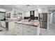 Modern kitchen featuring granite countertops, stainless steel appliances, and a spacious island at 3830 E Desert Cove Ave, Phoenix, AZ 85028
