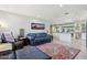 Open living space with stylish furniture, area rug and seamless flow into the updated kitchen at 3830 E Desert Cove Ave, Phoenix, AZ 85028
