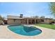 Refreshing backyard pool with a stone patio, perfect for summer fun and relaxation at 3830 E Desert Cove Ave, Phoenix, AZ 85028
